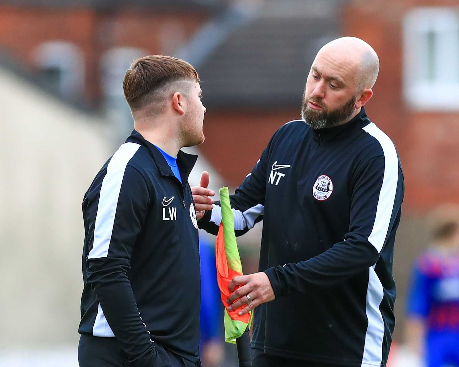 Two coaches speaking with each other